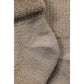 Detail van beige merinowollen thermosokken met zachte badstof